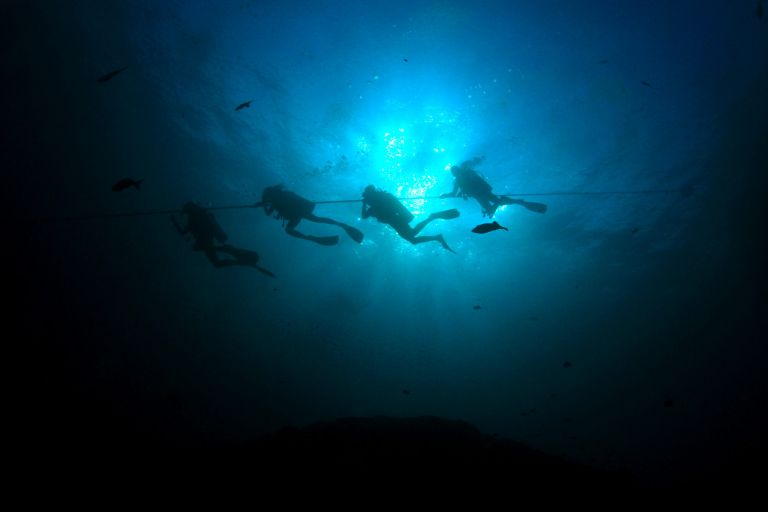 Scuba diving photo: divers descending silhouette